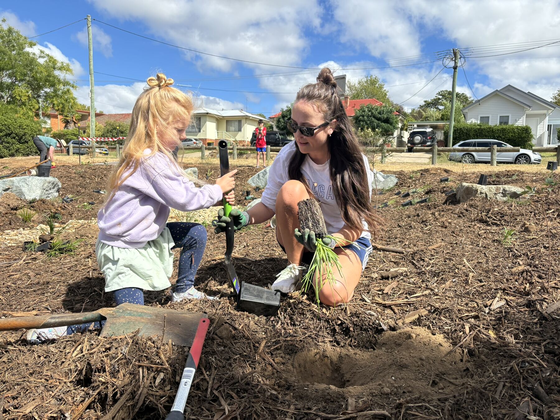 A child planting at a community planting day
